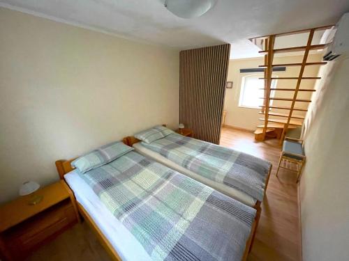 a small bedroom with two beds and a staircase at Haus am gelben Berg in Dittenheim