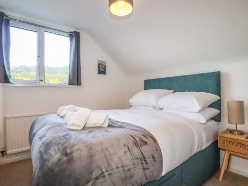 a bedroom with a large bed with two towels on it at Seacroft in Newquay
