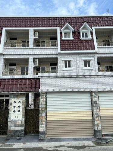 an apartment building with two garage doors in front at 凱莉民宿-花蓮包棟 in Hualien City