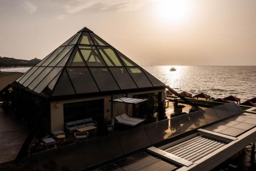 a house on a boat in the water at Cala Beach Resort in Punta Ala