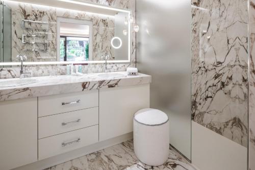 a bathroom with two sinks and a mirror at Cala Beach Resort in Punta Ala