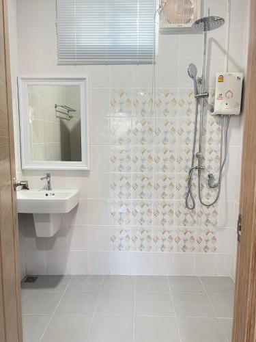 a bathroom with a shower and a sink at PICHAPON RESORT in Pak Chong