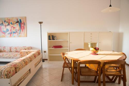 a living room with a table and a couch at Residence Il Patriarca in Viareggio