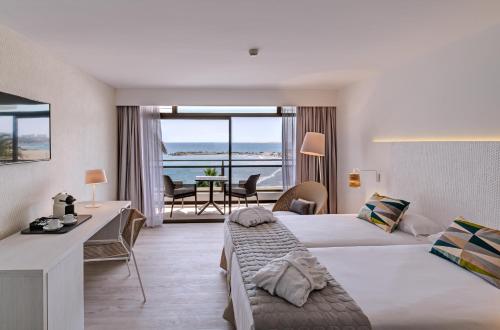 a hotel room with two beds and a view of the ocean at Don Gregory by Dunas - Adults Only in San Agustin