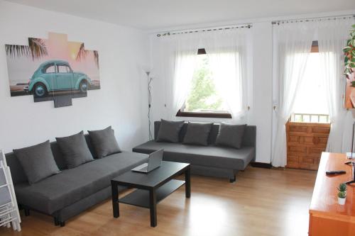 a living room with a couch and a table at Oasis Pirineos in Formigal