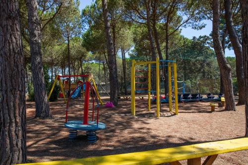 a playground in a park with trees at Gitavillage Argentario in Albinia