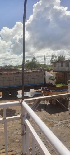 a train car is parked in a parking lot at Apartment behind Capricorn pub in Thika