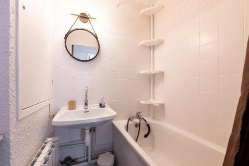 a bathroom with a sink and a toilet and a bath tub at Miquey - Appt proche station de ski in Villarembert