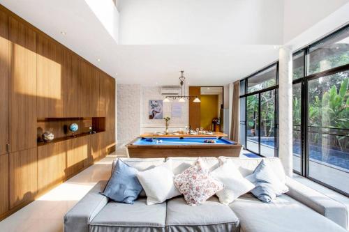 a living room with a couch and a pool table at Bangkok Luxury Pool Villa Thonglor in Bangkok