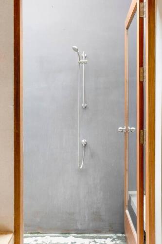 a shower stall in a bathroom with a mirror at Bangkok Luxury Pool Villa Thonglor in Bangkok