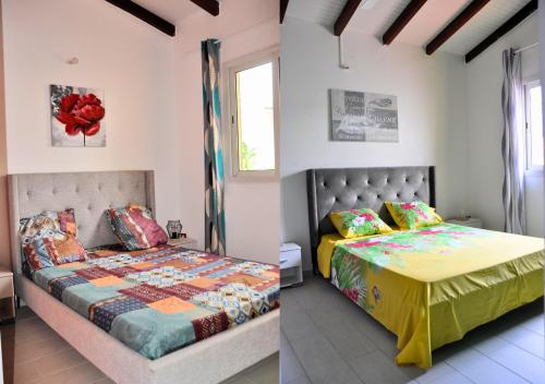 - une chambre avec 2 lits et une table dans l'établissement Maison Bel'o Kado-Charme Créole, à Capesterre-Belle-Eau