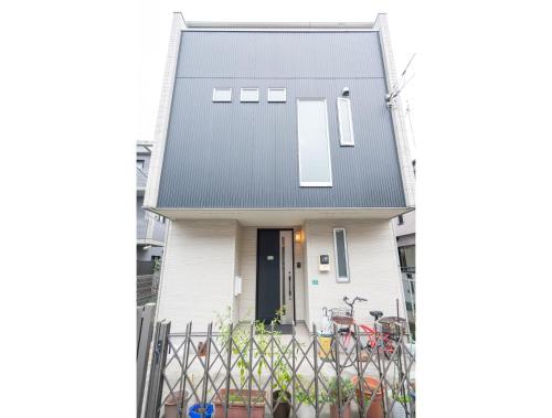 a white house with a black roof at 3 BR house 7 mins on foot from Otsuka on the Yamanote Line in Tokyo