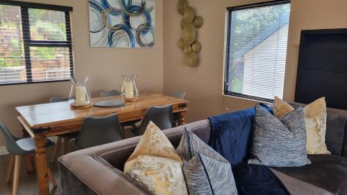 a living room with a couch and a table at Collards B&B in Durban