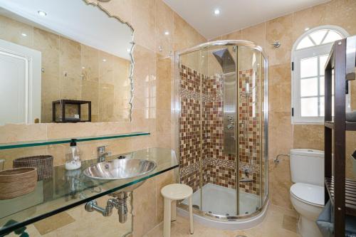a bathroom with a shower and a sink and a toilet at Casa Pia in Orihuela Costa
