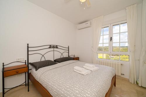 a bedroom with a bed with towels on it at Casa Pia in Orihuela Costa