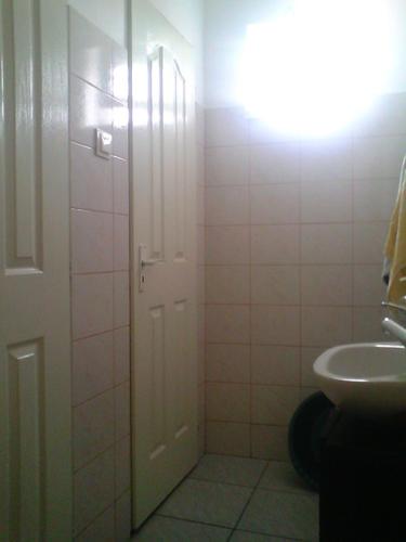 a bathroom with a white door and a sink at Casa Teo in Ocna Sibiului
