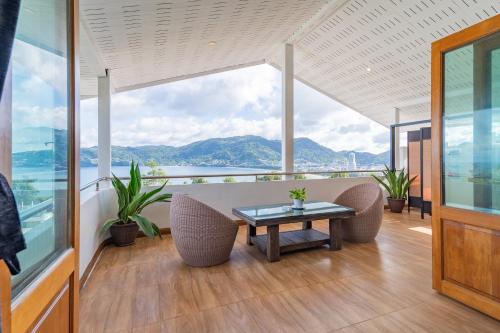a balcony with a table and chairs and a view at Patong Blue House Panorama View in Patong Beach