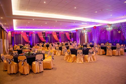 a banquet hall filled with tables and chairs with people at Tiger Palace By Soaltee in Bhairāhawā