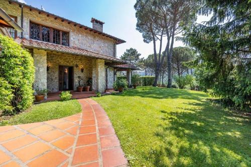una vista exterior de una casa con un patio de césped en Villa ai Boschetti, en Luciano