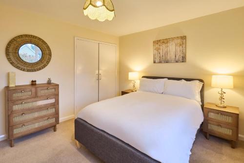 a bedroom with a large white bed and two night stands at Host & Stay - Mayfield in Blean