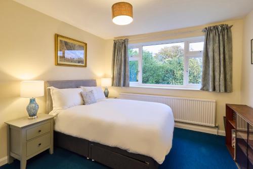 a bedroom with a large bed and a window at Host & Stay - Mayfield in Blean