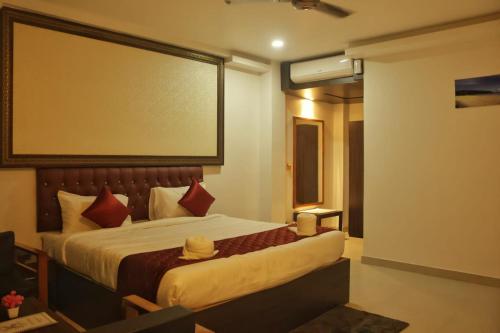 a bedroom with a large bed with a large window at Hotel Havelock Gateway in Havelock Island