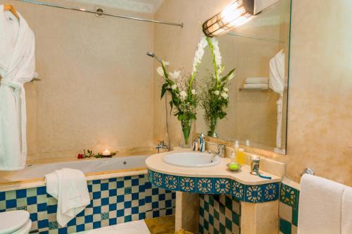 łazienka z umywalką, toaletą i wanną w obiekcie Villa Des 3 Golfs w Marakeszu