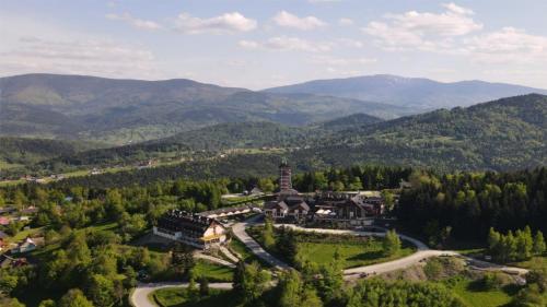 an aerial view of a resort in the mountains at Hotel Beskidzki Raj Medical SPA in Stryszawa