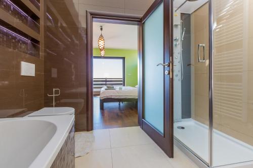 a bathroom with a tub and a shower and a sink at Holiday Home Villa Lion's House in Crikvenica