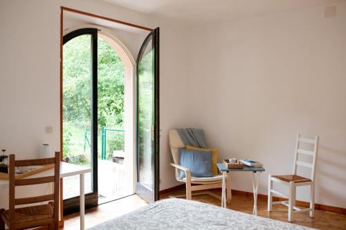 a bedroom with a mirror and a table and a chair at La Beuratte in Cornimont