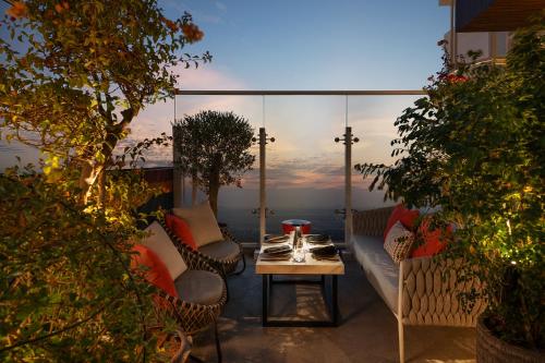 a patio with a table and chairs and a window at Radisson Dubai Damac Hills in Dubai