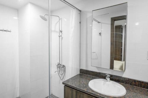 a bathroom with a sink and a shower at Ho Cozy Đà Lạt Center in Da Lat