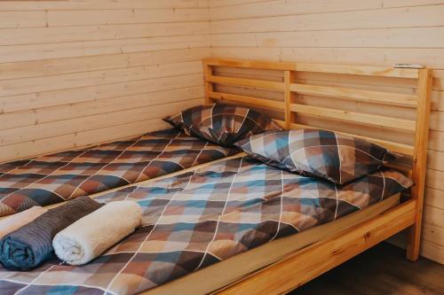 a bed with two pillows on it in a room at Melamar in Smārde