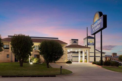 a building with a sign in front of it at Days Inn by Wyndham Oklahoma City in Oklahoma City
