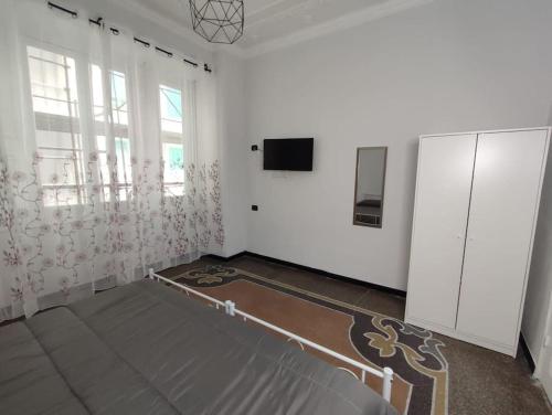 a room with a bed and a television in it at Benny appartamento 3 CAMERE DA LETTO ad uso ESCLUSIVO Genova Aeroporto in Genoa