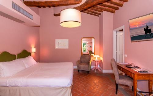 a bedroom with a bed and a desk and a desk at Hotel Albergo Villa Marta in Lucca