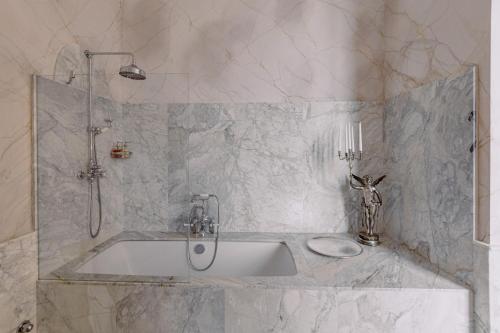 a white bathroom with a sink and a shower at Castello di Casalborgone, Luxury Italian Castle Hotel in Casalborgone