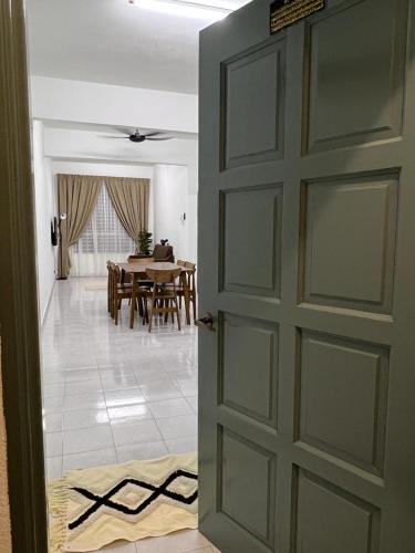 a door leading to a dining room with a table at 162 RESIDENCY SELAYANG in Batu Caves