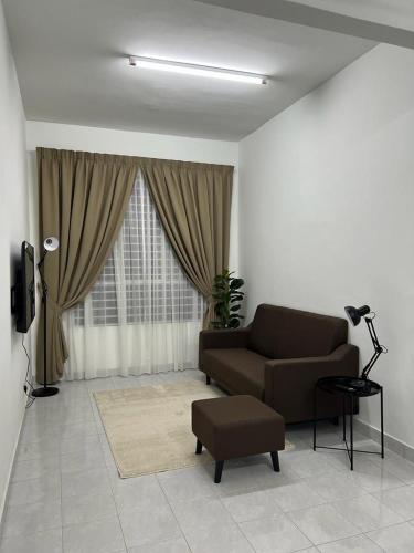 a living room with a couch and a window at 162 RESIDENCY SELAYANG in Batu Caves