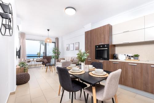 a kitchen and living room with a table and chairs at Quattro Sea View Beachfront Ap.206 in Larnaca