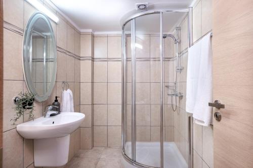 a bathroom with a sink and a shower at Quattro Beachfront Sea View Ap 206 in Larnaka