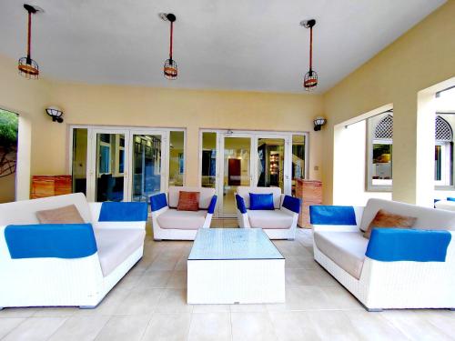 a living room with white couches and a coffee table at Royal private pool, Lux 7-bedroom villa on Marina in Dubai