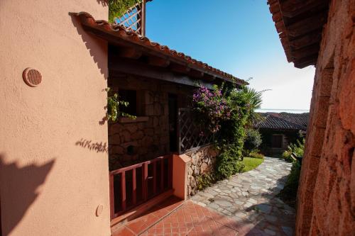 a stone house with a gate and a walkway at Galathee Sea View in Puntaldia