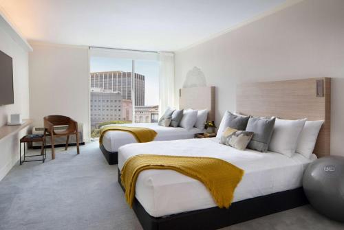 a hotel room with two beds and a large window at BEI San Francisco, Trademark Collection by Wyndham in San Francisco