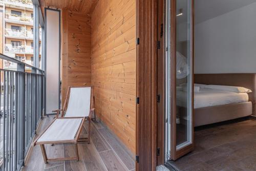 a room with a chair and a bed on a balcony at Luxury apartment - Free Parking - Duomo-Navigli in Milan