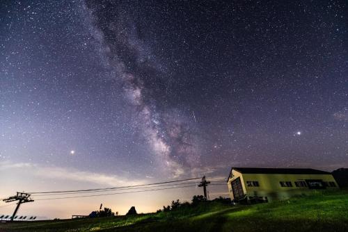 a starry night with a house and the milky way at FLYING HOUSE in Chikuni
