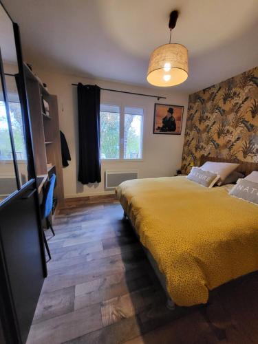 a bedroom with a yellow bed and a window at L'eau douce in Gasques