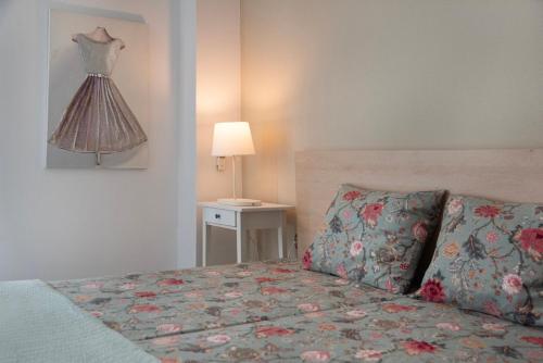 a bedroom with a bed and a dress hanging on the wall at Vicky's Sky Loft in Piraeus