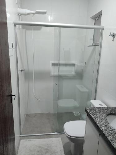 ein Bad mit einer Glasdusche und einem WC in der Unterkunft Hotel Morro do campo in Antônio Carlos