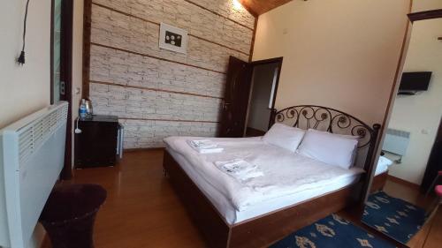 a small bedroom with a bed in a room at Kefilyan Family Hotel in Haghpat